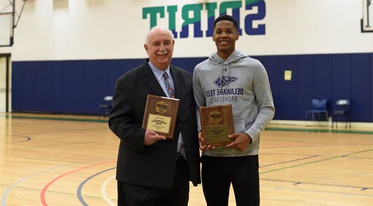 Basketball player Rashaan Butler standing beside his coach Richard Rago